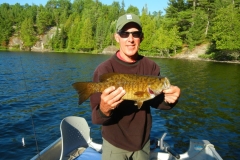 Angler with Great Catch Smallmouth on the Water