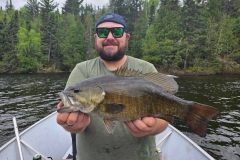 Angler with Large Bass Catch in Remote Ontario