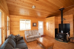 Seating Area Beside Wood Stove At Fly-In Cabin