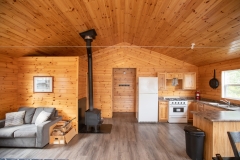 Living Area With Wood Stove At Outpost Cabin
