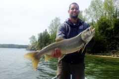 Angler Showing Large Trout in Bright Daylight