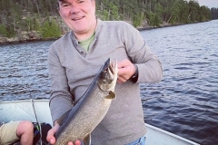 Smiling Angler With Lake Trout on Blue Water