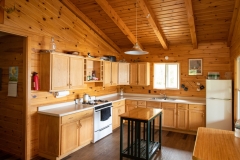 Kitchen With Island At Loonhaunt Lake Cabin