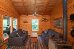 Living Room With Wood Stove At Outpost Cabin