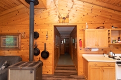 Wood Stove And Kitchen View At Outpost Cabin