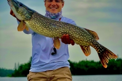 Angler Presenting Large Pike at Boat Bow