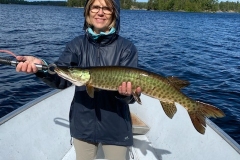 Angler Holding Long Pike on Open Blue Lake