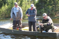 Group Displaying Pike Catch in Wilderness Bay