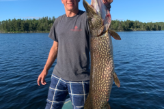 Massive Pike Held Across the Boat Rail