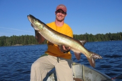Smiling Angler with Pike Before Island Treeline