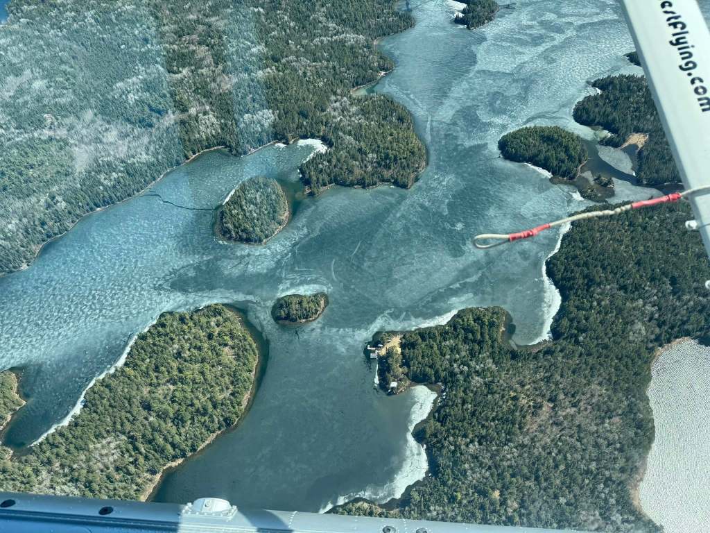 Aerial view of ice out on a spring shoreline scene on a Northwestern Ontario fly-in lake