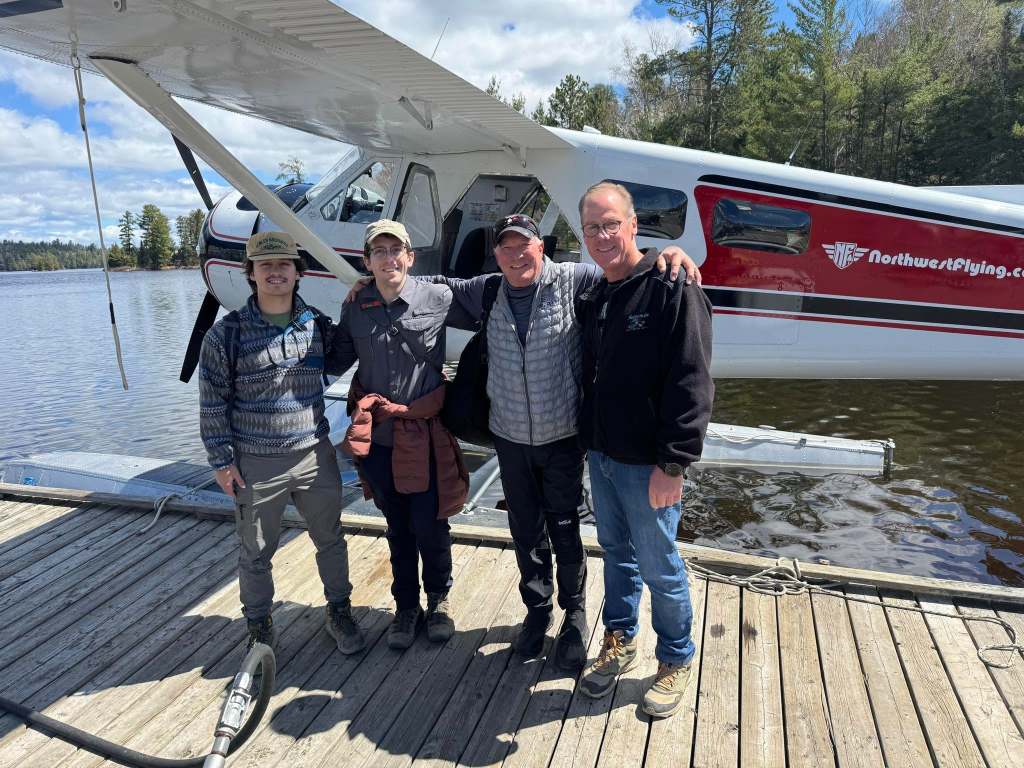 The Carlson group on the float in front of a Northwest Flying floatplane at Shingwak Lake, Ontario, 2026