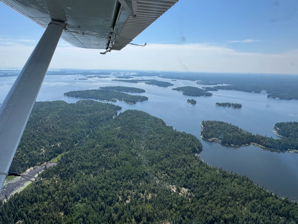 Aerial view of lakes, islands and boreal forest north of Nestor Falls, Ontario, photographed from a Northwest Flying floatplane, July 2026